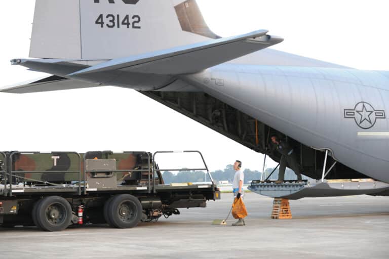 Airmen move a Patriot missile into a C-130J Super...