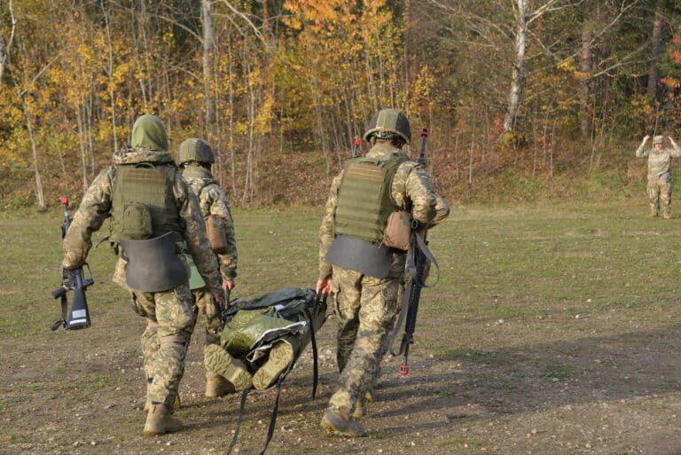 Soldiers with the Armed Forces of Ukraine carry a...
