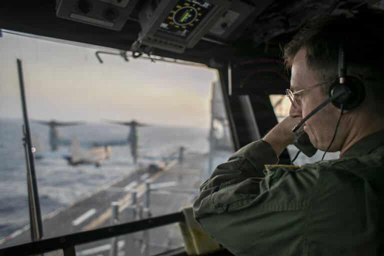 A naval officer aboard USS Tripoli (LHA 7) oversees...