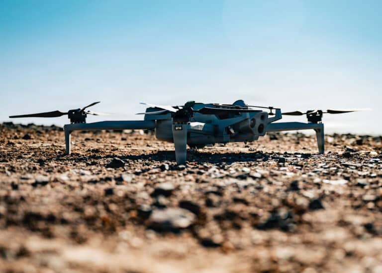 A drone sits on the ground before being flown during an...