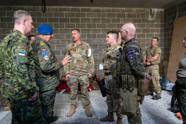 Exercise directors from Germany, center left, and...
