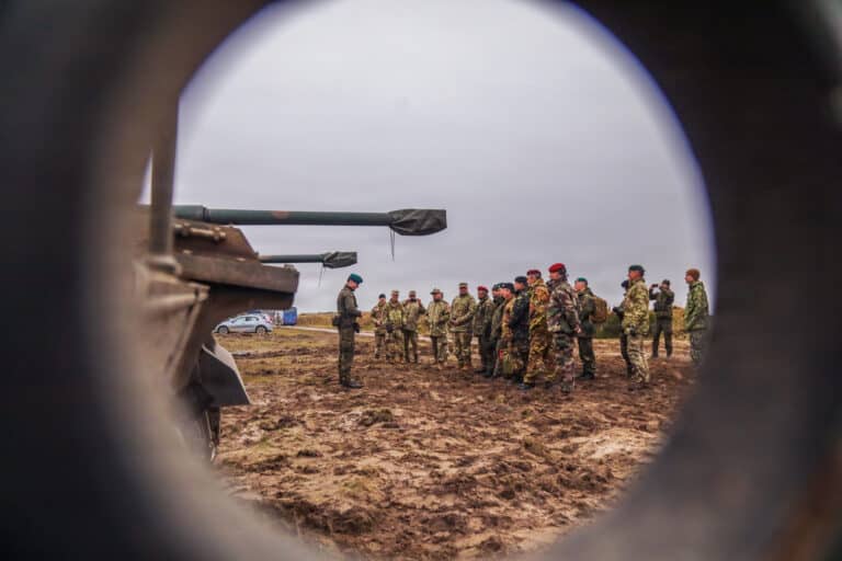 Leaders from multiple nations receive a briefing about...