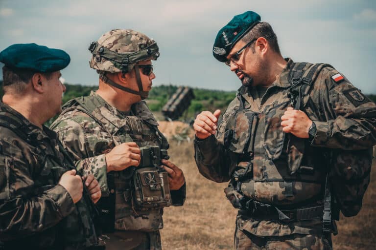U.S. Army Chief Warrant Officer 2 Eric Land, center,...