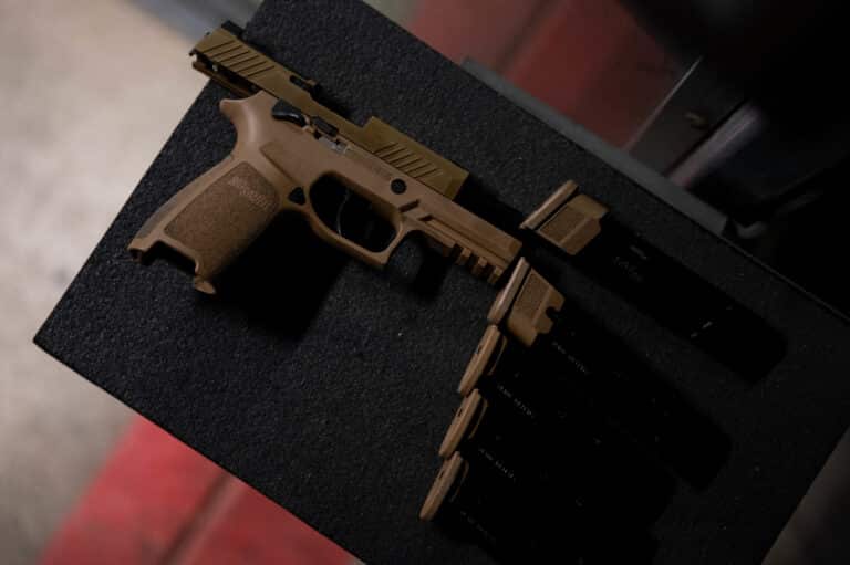 A SIG Sauer P320 M18 pistol sits atop a shelf prior to a...