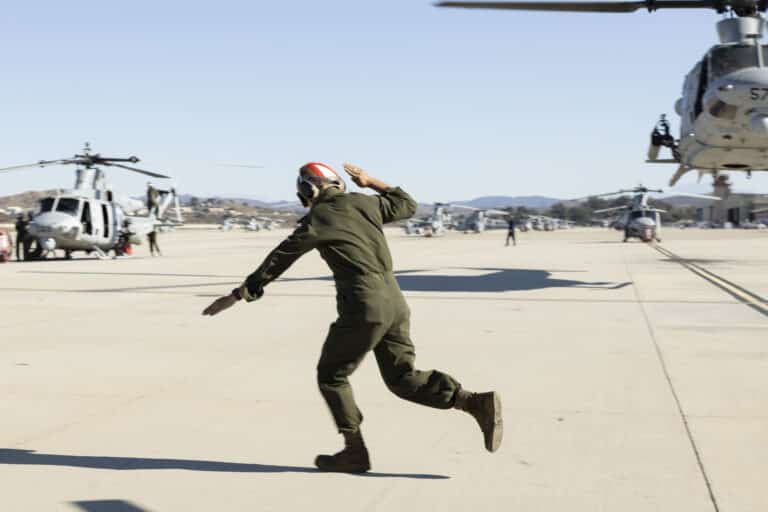 A U.S. Marine sends off a UH-1Y Venom piloted by U.S....