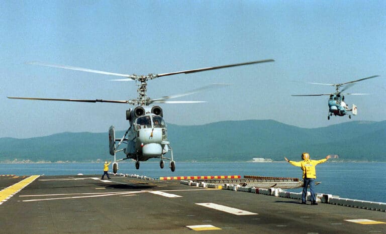 Two Russian KA-27 Helix helicopters prepare to land on...
