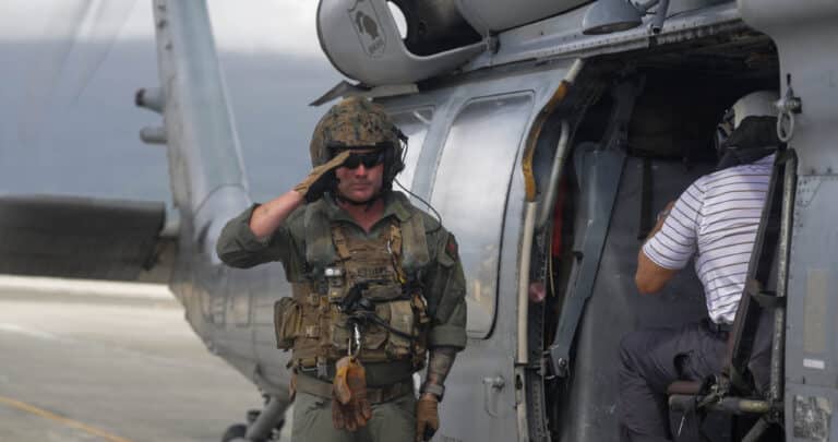 A U.S. Marine salutes as the Honorable Hung Cao, Acting...