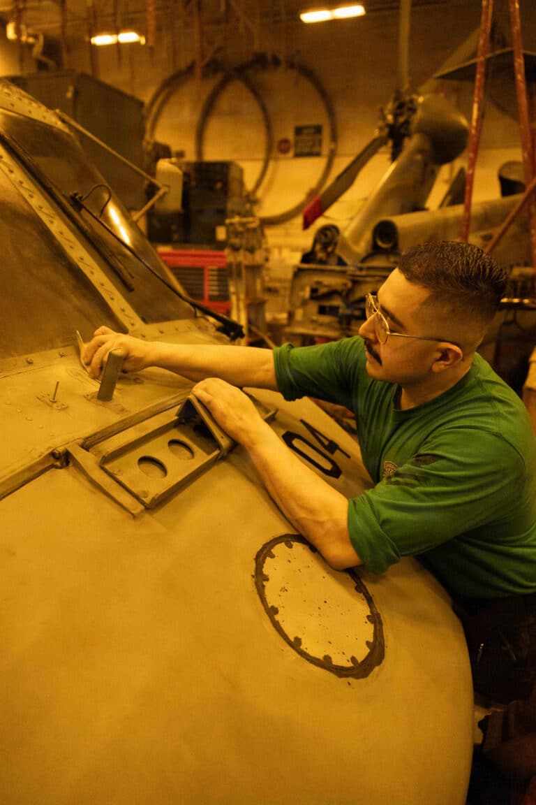 A U.S. Sailor maintains an MH-60R Sea Hawk, attached to...