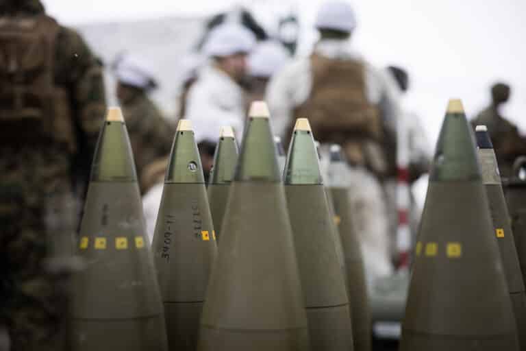 M795 155mm projectiles are staged to be fired from M777...