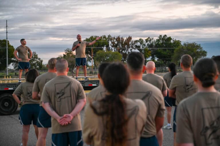 150SOW Airmen listen to Col. Christopher George, 150...