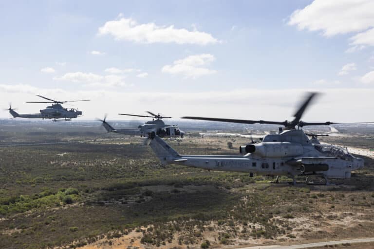 A U.S. Marine Corps UH-1Y Venom, center, and two AH-1Z...