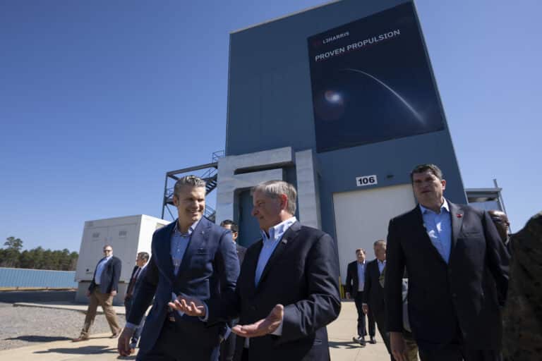 Secretary of War Pete Hegseth walks with L3Harris CEO...