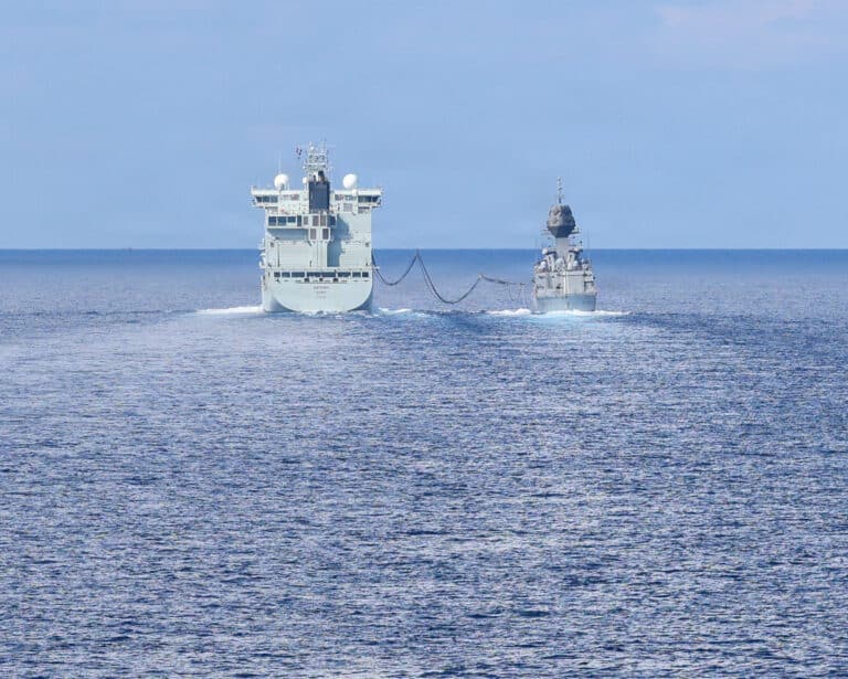 Canadian supply ship MV Asterix extends its fuel boom to...