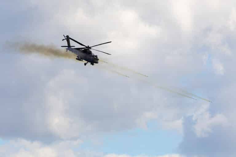 A U.S. Army AH-64E Apache conducts a strafing run near...