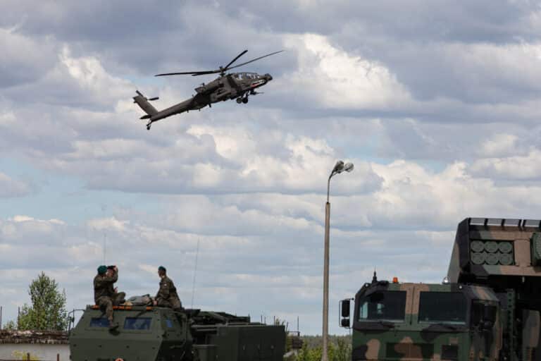 A U.S. Army AH-64E Apache conducts a strafing run near...