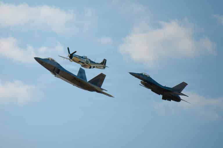 A U.S. Air Force F-22 Raptor, P-51 Mustang and F-16...
