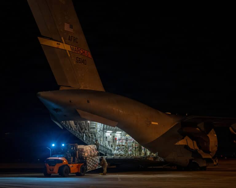 U.S. Air Force Airmen load disaster assistance cargo...